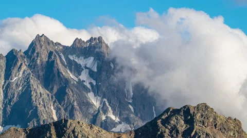 Puffy clouds over the mountains. 動画素材 148161343