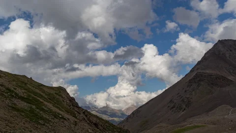 Puffy clouds over the mountains. Stock Footage 172186308