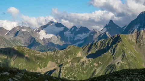 Puffy clouds over the mountains. 動画素材 195156950