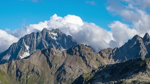 Puffy clouds over the mountains. 動画素材 196070926