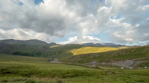 Puffy clouds over the snowy mountain pick. 動画素材 169911503