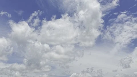 Puffy Cumulus Clouds Drifting in Bright Blue Daytime Sky Stock Footage 344272334