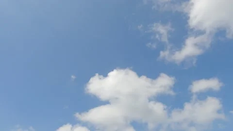 Puffy fluffy white cloud on beautiful sunny clear blue sky background Stock Footage 148189343