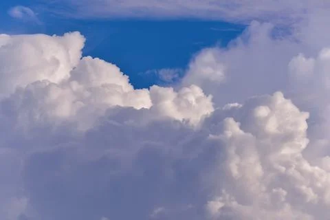 Puffy fluffy white clouds against daytime sky. Stock Photos