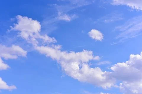 Puffy fluffy white clouds against daytime sky. Stock Photos