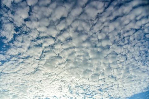 Puffy fluffy white clouds against daytime sky. Stock Photos