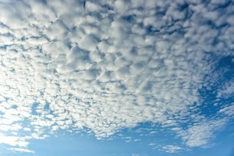 Puffy fluffy white clouds against daytime sky. Stock Photos