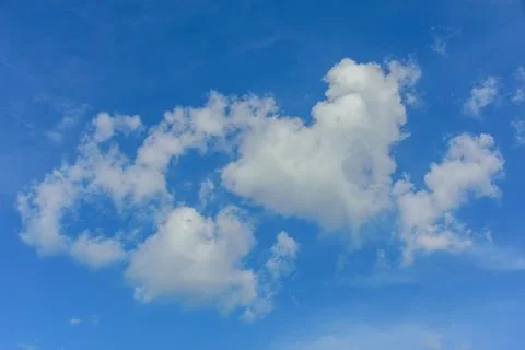 Puffy fluffy white clouds against daytime sky Stock Photos