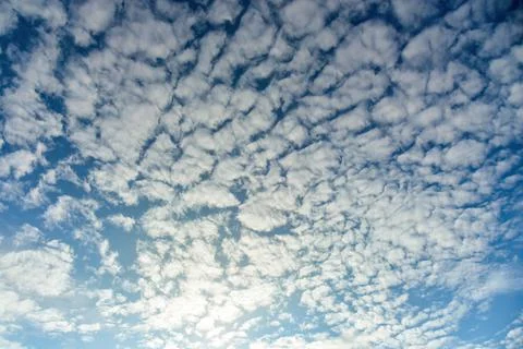Puffy fluffy white clouds against daytime sky. Stock Photos