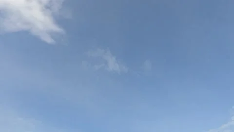 Puffy fluffy white clouds on beautiful sunny clear sky background Stock Footage 147113311