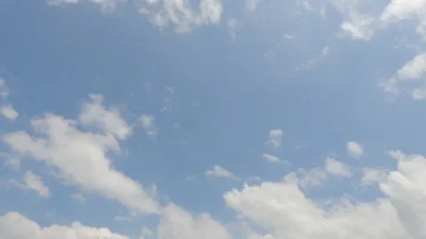 Puffy fluffy white clouds on beautiful sunny clear sky background Stock Footage 147113377