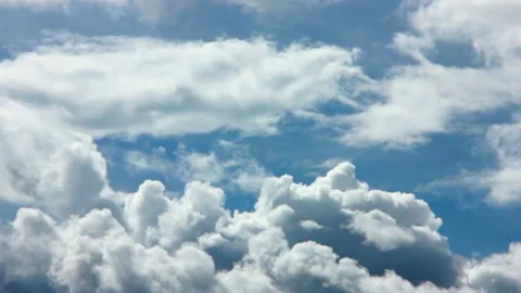 Puffy fluffy white clouds blue sky time lapse motion background. Stock Footage 188235554