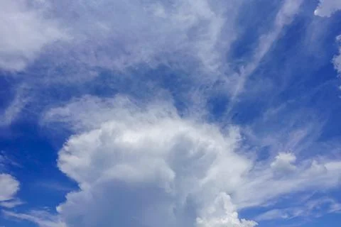 Puffy fluffy white clouds blue sky. Stock Photos
