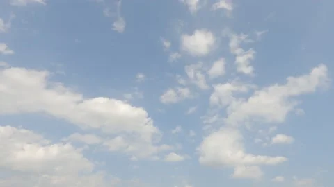 Puffy fluffy white clouds moving on beautiful sunny clear blue sky Stock Footage 151446995