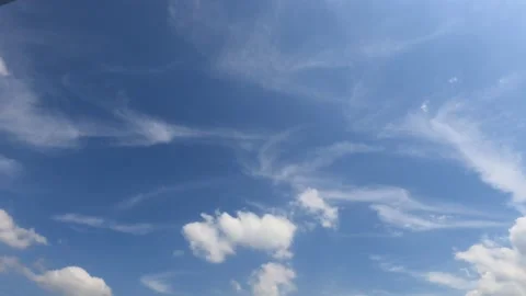 Puffy fluffy white cumulus clouds on beautiful sunny clear sky background Stock Footage 147113444