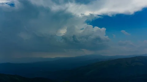 Puffy Stormy Clouds Over A Mountain Chain 動画素材 90739573
