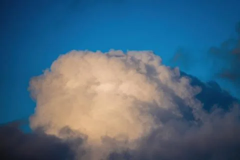 Puffy white cloud on clear blue sky Stock Photos