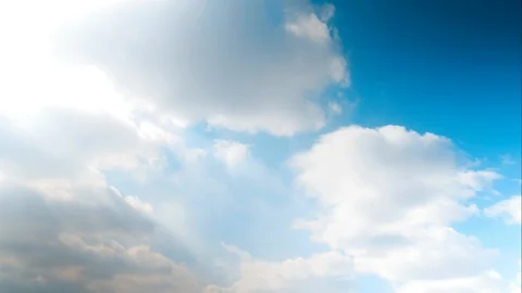 Puffy white clouds blue sky puffy time lapse motion background. Bright blue s Stock-Footage 106197527