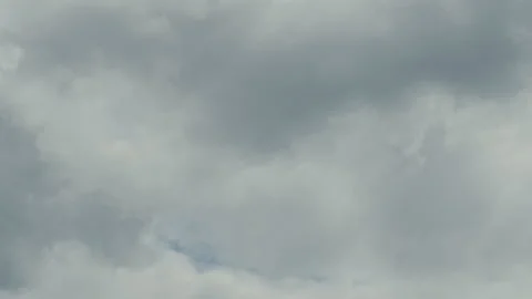 Puffy white clouds dynamically cover the sky Stockbeeldmateriaal 261493045