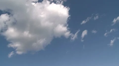 Puffy white clouds over a sandy shoreline (1 of 6) Stock Footage 10785930