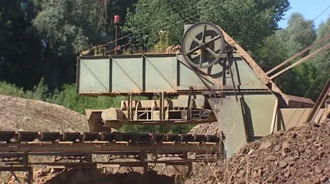 Pug milling machine with rotating blades scrapes clay from piles - medium shot Stock Footage 42778394