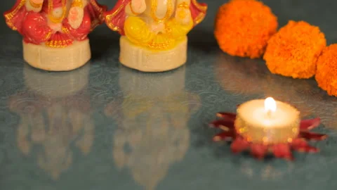 Puja thali/plate with a tiny decorative wax lamp lighted for worship during D... Stock Footage 155088213