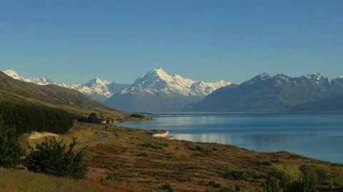 Pukaki lake reflecting distant Mt Cook in New Zealand with snow cap as 4k. Stock Footage 229930318