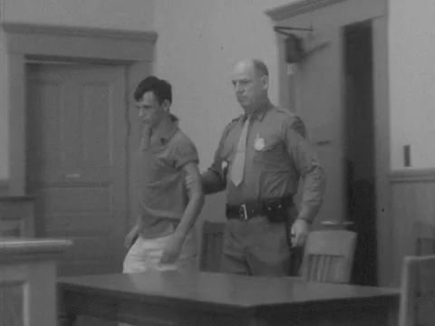 Pulaski, VA - 7/31/59: Bailiff brings defendant into courtroom 스톡 동영상 234239396