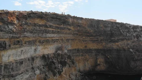 Pull Up Aerial Drone Shot of two persons standing on top of cliffs Stock Footage 111266007