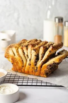 Pull-apart bread with cream cheese, cinnamon, chocolate, prunes, nuts, with Stock Photos