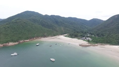 Pull away aerial shot over pristine beach in Sai Kung, Hong Kong. Stock Footage 109392445