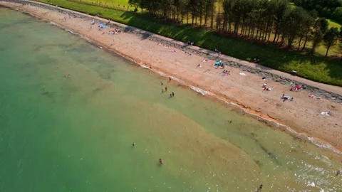 Pull-away aerial video of Helen's Bay beach in County Down, Northern Ireland on Stock Footage 316710757
