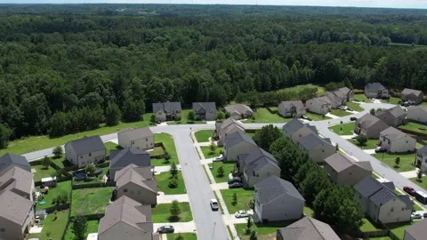 Pull away drone aerial view over an American lush green suburban neighborhood. Stock Footage 170721590