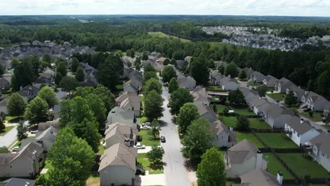 Pull away drone aerial view over an American lush green suburban neighborhood. Stock Footage 170721644