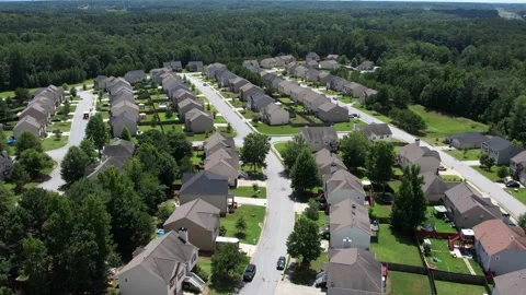 Pull away drone aerial view over an American lush green suburban neighborhood. Stock Footage 170722077