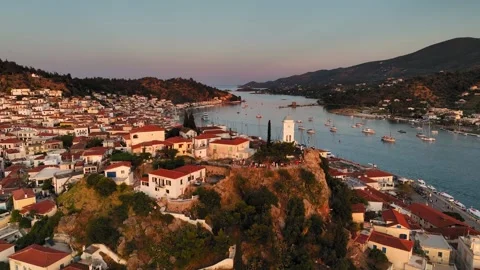 Pull-away Drone footage of sunset at sea and sailing boats in Poros port town Stock Footage 341302420