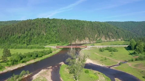 The pull away shot from the area with a railway bridge over the river. Stock Footage 116653368