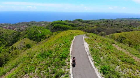 Pull away shot of a scooter on a mountain in Bali 4K Stock Footage 168048757