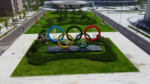 Pull away view Olympics rings logo with various sports figurines integrated for Stock Footage 318527073