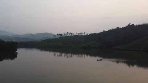 Pull Back Across Lake with Boat Reveal Stock Footage 255030810