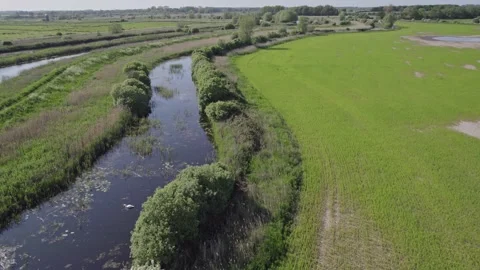 Pull back aerial footage over the agricultural fields Stock Footage 242441062