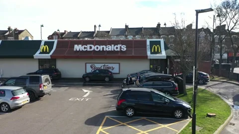 PULL BACK AERIAL OF GUYS EATING INFRONT OF MC DONALDS Stock-Footage 149947402