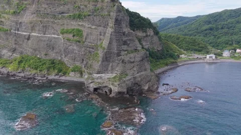 Pull-Back Aerial of Seta Kamui Rock Opening to Full Coastline View – 4K Stock Footage 321990630