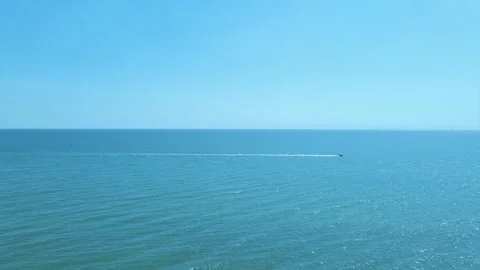 Pull back aerial shot of a jet ski on the sea - Brighton Beach Stock Footage 158094675