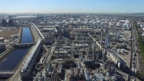Pull Back Aerial Shot revealing an Industrial District with huge American Flag Stock Footage 69097244