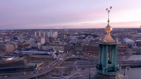 Pull-back aerial shot of the top of the City Hall in Stockholm during sunset Stock Footage 129415245
