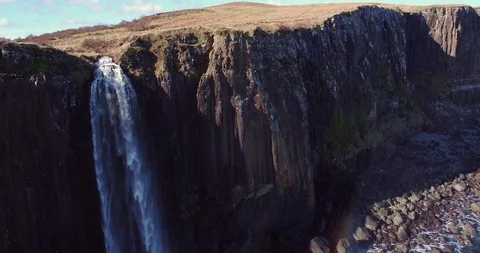 Pull back aerial shot of the waterfall and dramatic coastline drone aerial 4K Stock Footage 104582388