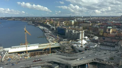 Pull back aerial of Slussen &amp; Golden Bridge construction site in Stockholm Stock Footage 129650158