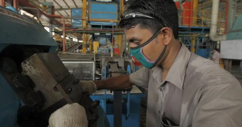 Pull Back and Medium Shot of Worker Using Industrial Equipment (4K) Stock Footage 60762593