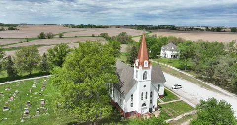Pull back ascending flight viewing the church and surrounding countryside Stock Footage 335670051